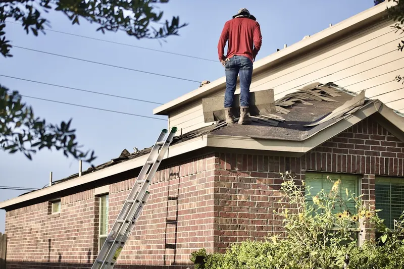 Professional roofer working on a residential roof in Rubicon Properties
